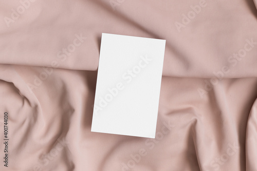 White business card mockup on a beige textile. 85x55mm