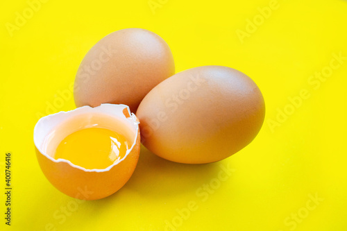 Closeup cracked brown eggs Buy from supermarket Placed on a yellow background.