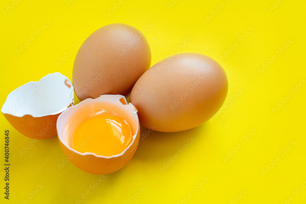 Closeup cracked brown eggs Buy from supermarket Placed on a yellow background. Closeup cracked brown eggs Buy from supermarket Placed on a yellow background.
