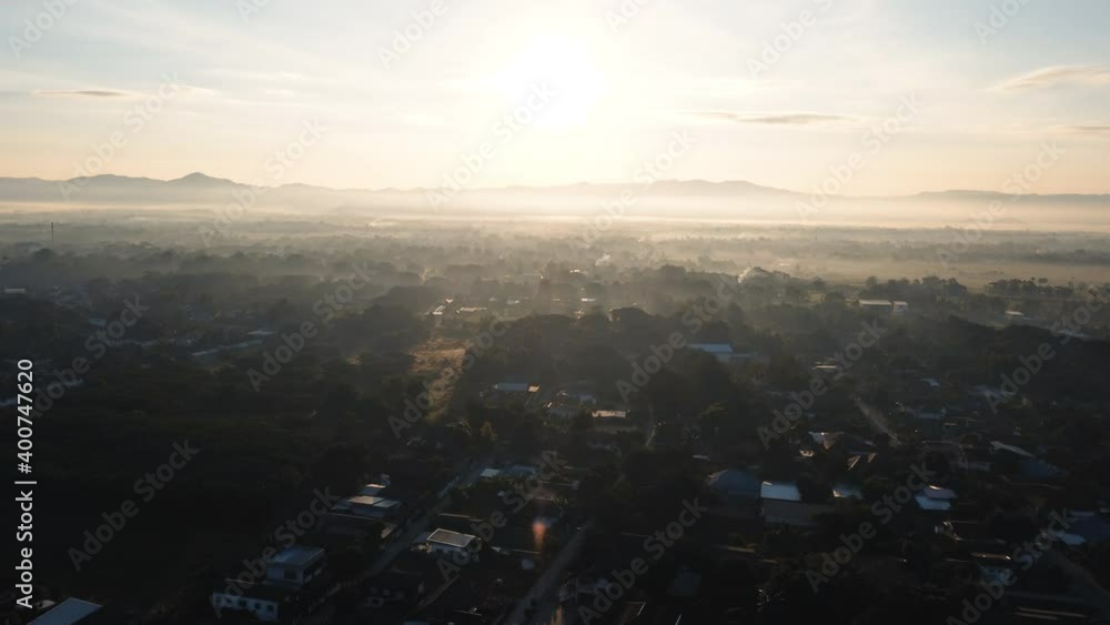 Establishing Aerial View Shot of sunrise with fog above asia village, Thailand. Establishing Aerial View Shot of sunrise with fog above asia village, Thailand.