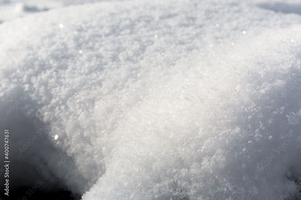 Winter scene with closeup of the snow. Cold season weather forecast. Snowy sunny background