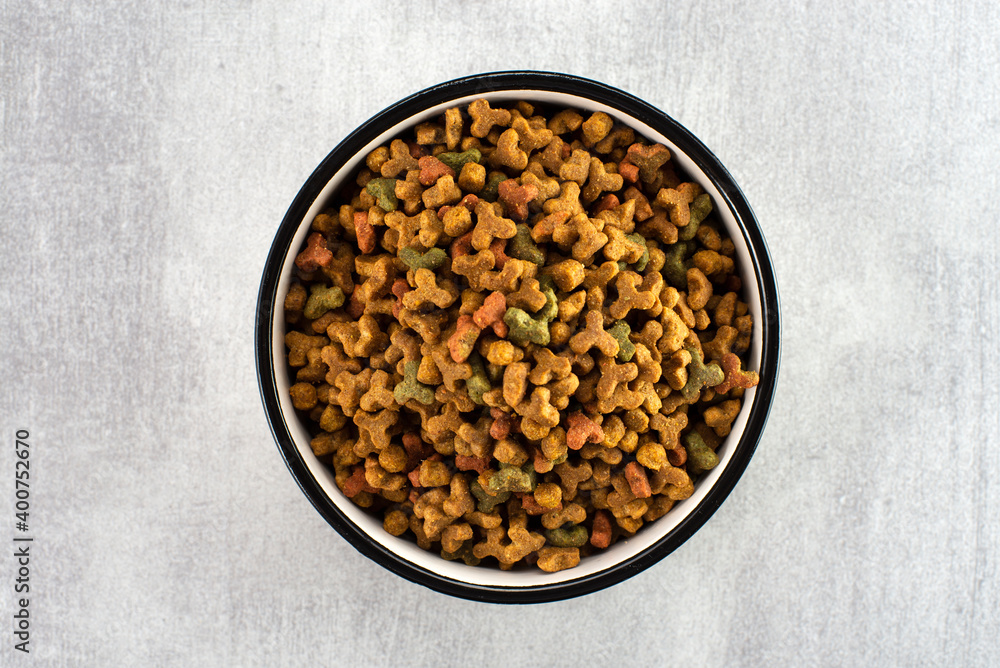 Pet food in a bowl on a gray background. View from above Pet food in a bowl on a gray background. View from above
