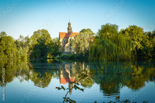 An old monastery in an idyllic atmosphere on a lake in sunshine