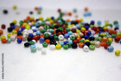 Colorful beads on a white felt background.