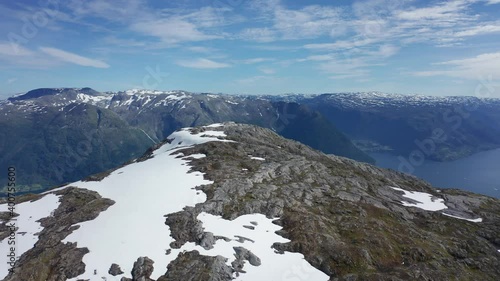 Aerial orbiting view epic mountain Oksen with snow, fjord Background - Norway. photo