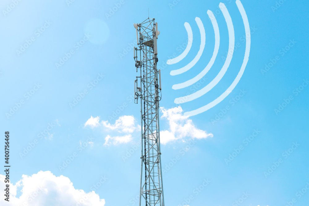 a radio tower with antennas that broadcasts a signal against the background of a blue sky with clouds a radio tower with antennas that broadcasts a signal against the background of a blue sky with clouds