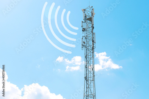 a radio tower with antennas that broadcasts a signal against the background of a blue sky with clouds