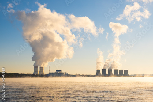 Smoke is released into the atmosphere from the cooling tower of the nuclear power plant emissions. Environmental pollution. Ecology