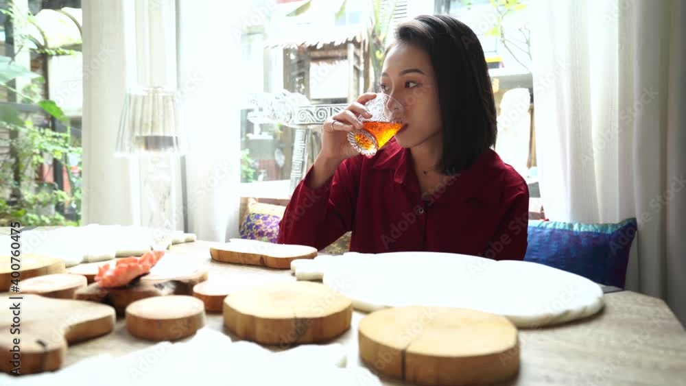 Ethnic woman having breakfast in hotel with oriental interior design Ethnic woman having breakfast in hotel with oriental interior design