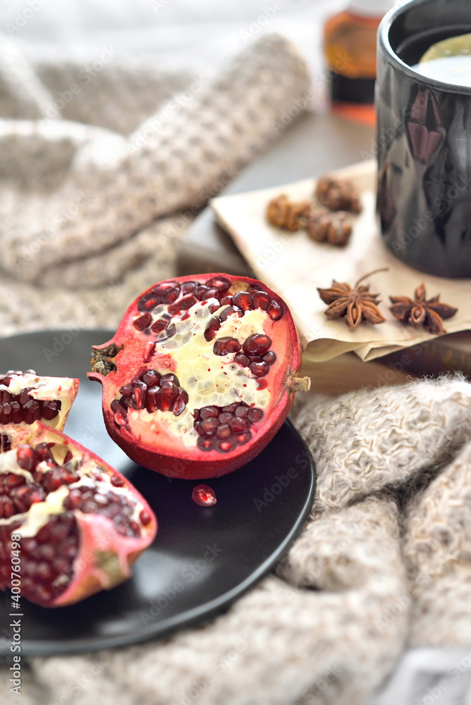 Natural flu home remedies: hot tea cups with lemon and walnut and pomegranate to boost immune system. Natural healthy food and hot drink ingredients for immunity stimulation and against viruses. Natural flu home remedies: hot tea cups with lemon and walnut and pomegranate to boost immune system. Natural healthy food and hot drink ingredients for immunity stimulation and against viruses.