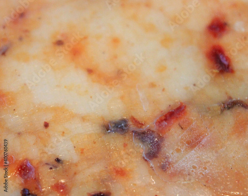 farmer's cheese crust of the cheese with the beans inside. texture as they Mature-hand-job. pieces of cheese on a cutting Board in different colors-orange marble Derby with paprika and tomato. High