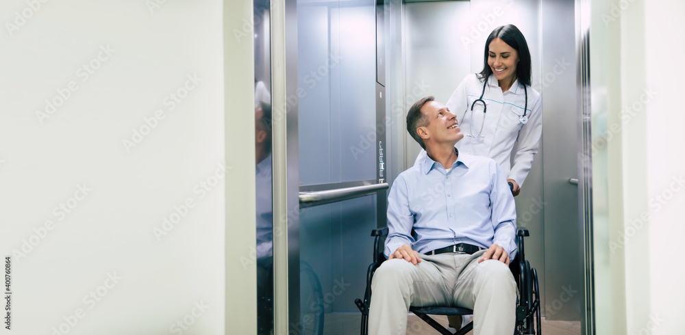 Senior handsome man in a wheelchair is moving in the hospital with help of medical special staff Senior handsome man in a wheelchair is moving in the hospital with help of medical special staff