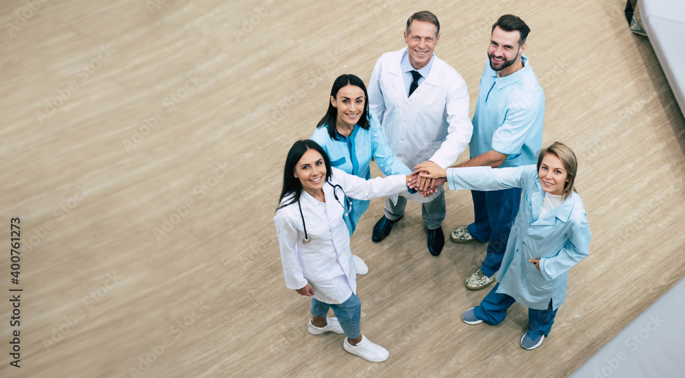 Top view full-length photo of happy successful medics team while conversation at the hospital Top view full-length photo of happy successful medics team while conversation at the hospital