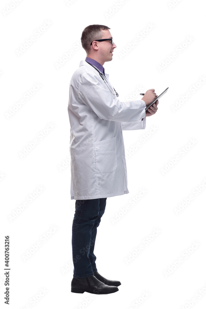 Side view of concentrated male doctor writing reports Side view of concentrated male doctor writing reports