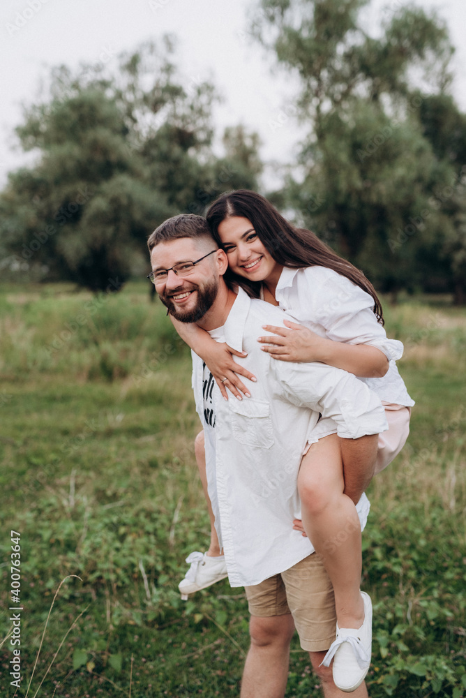 Naklejka premium young couple in love a guy with a beard and a girl with dark hair in light clothes