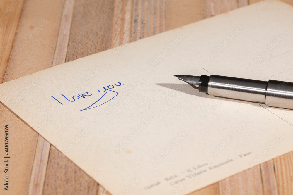 An old postcard with the words 'I love You' and a fountain pen. An old postcard with the words 'I love You' and a fountain pen.