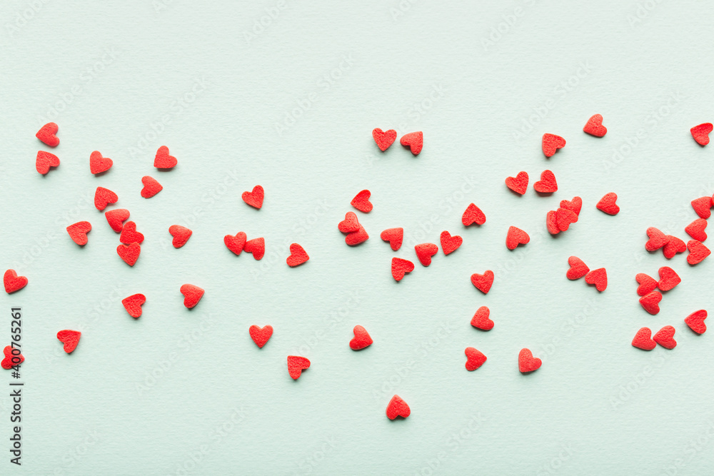 red and turquoise pattern background for Valentine's day. red hearts are evenly spread out on surface