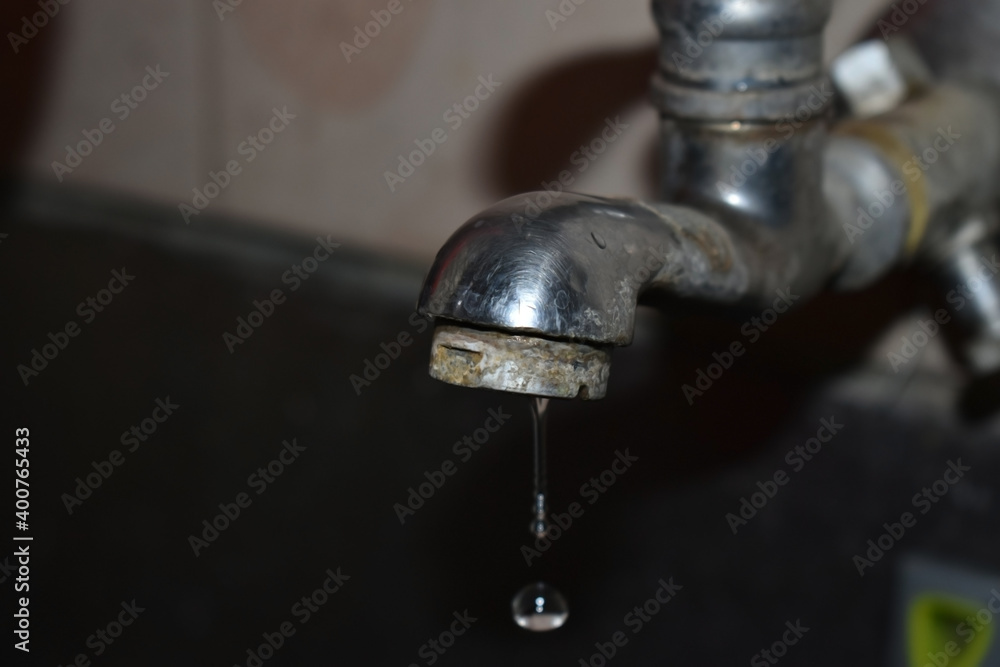 Undermaintained water tap leaking small amount of water causing water