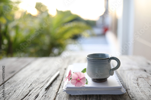 Asian clay ceramic cup and flower and notebook 