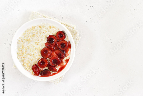 Healthy oatmeal porridge with cherry slices