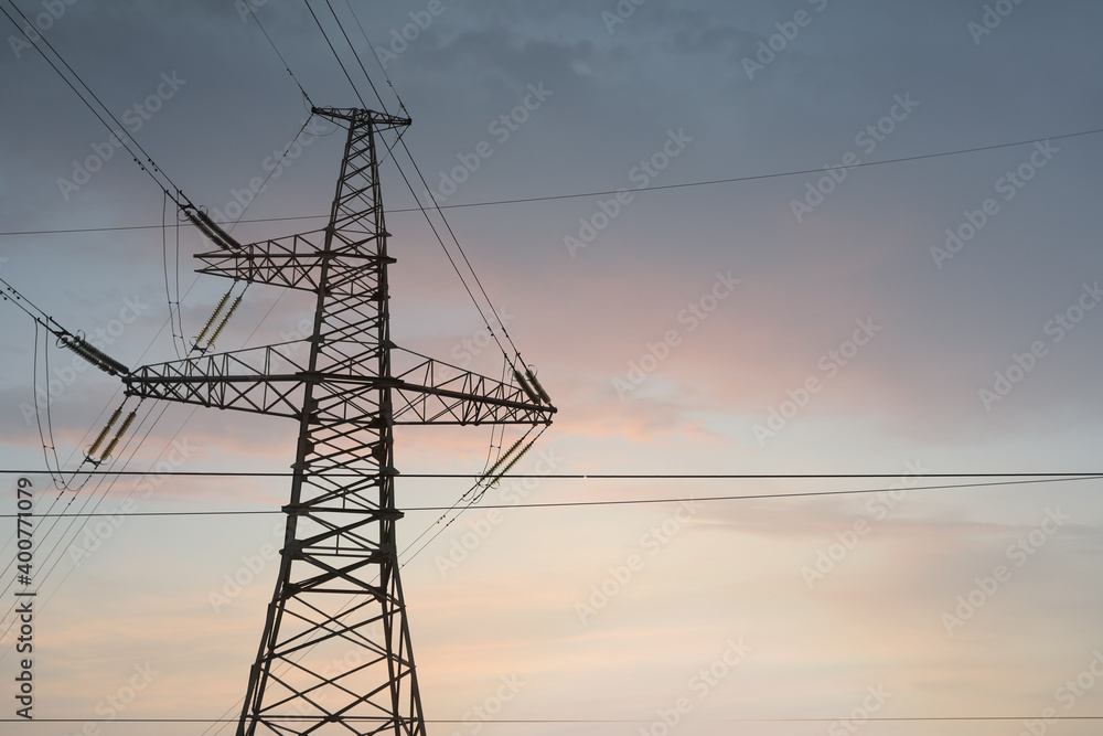 High voltage tower at sunset, low angle view