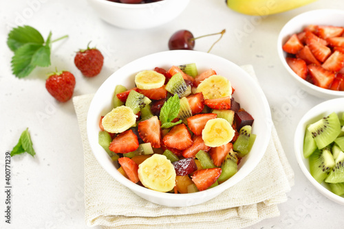 Healthy breakfast with fruit salad from strawberry, kiwi and banana