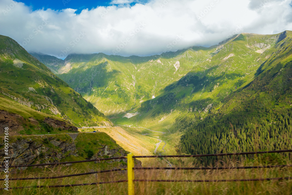 Romanian Carpathian mountains on a summertime. Amaizing view on the mountains and cloudy sky from Transfagarasan alpine mountain road, Fagaras Mountains, Transylvania, Romania. Travel backdrop Romanian Carpathian mountains on a summertime. Amaizing view on the mountains and cloudy sky from Transfagarasan alpine mountain road, Fagaras Mountains, Transylvania, Romania. Travel backdrop
