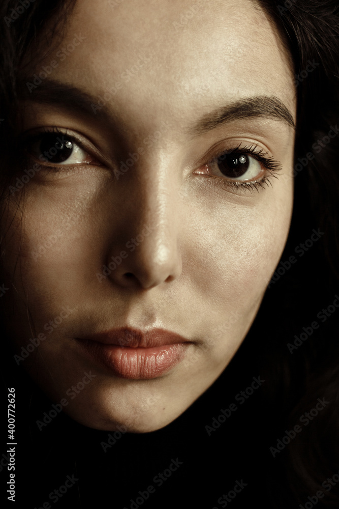 Portrait of beautiful brunette young woman in black looking at camera. Portrait of beautiful brunette young woman in black looking at camera.