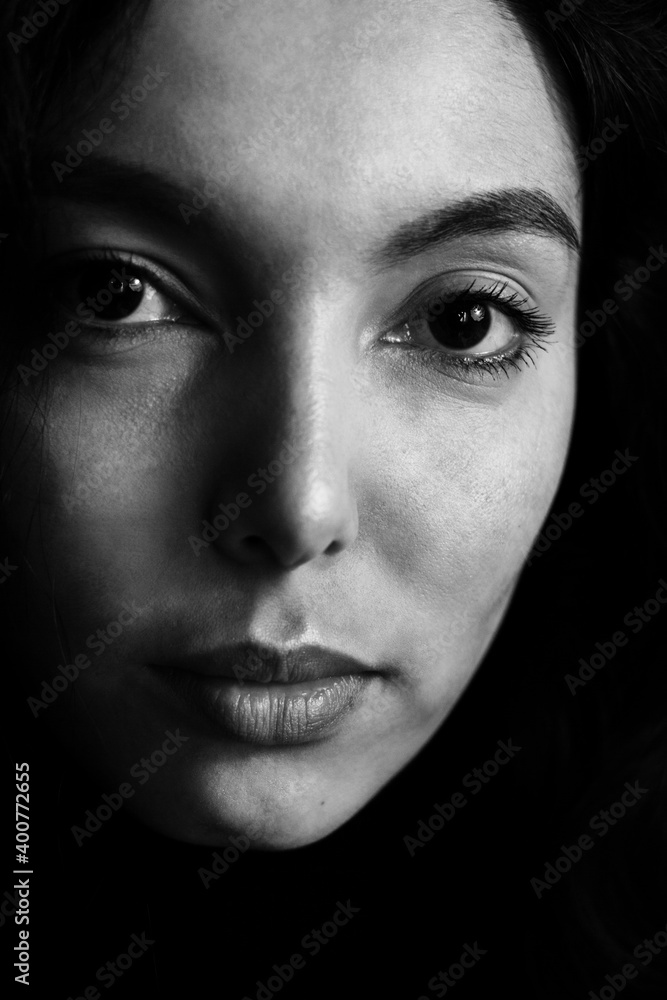 Portrait of beautiful brunette young woman in black looking at camera. Portrait of beautiful brunette young woman in black looking at camera.