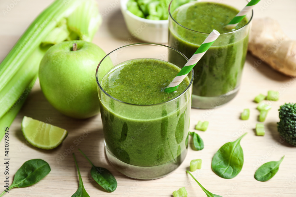 Delicious fresh green juice on wooden table Delicious fresh green juice on wooden table