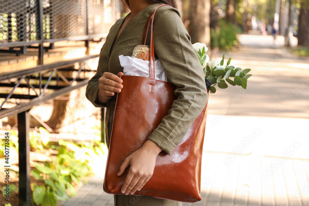 Woman with leather shopper bag on city street, closeup - obrazy, fototapety, plakaty 