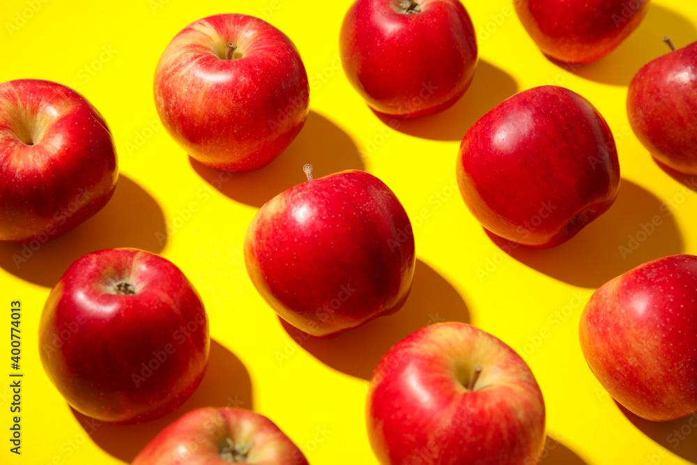 Fresh ripe red apples on yellow background Fresh ripe red apples on yellow background