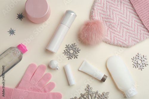 Flat lay composition with different cosmetic products on beige background. Winter care