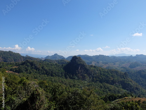 landscape in the mountains and forest. Clear blue sky with green forest.