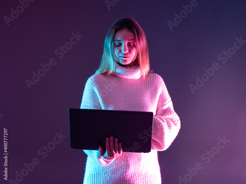 Girl stands and holds a lap...