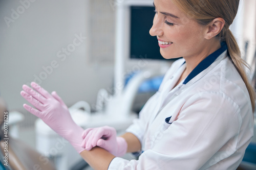 Happy young female dentist in modern office