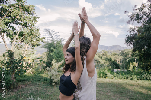 White hippie couple doing healthy meditation yoga and relationship body practice during sunset time in the nature