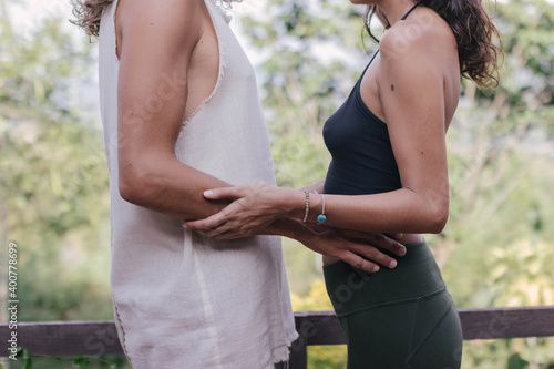 White hippie couple hug and support each other in yoga clothers during sunset time in the nature