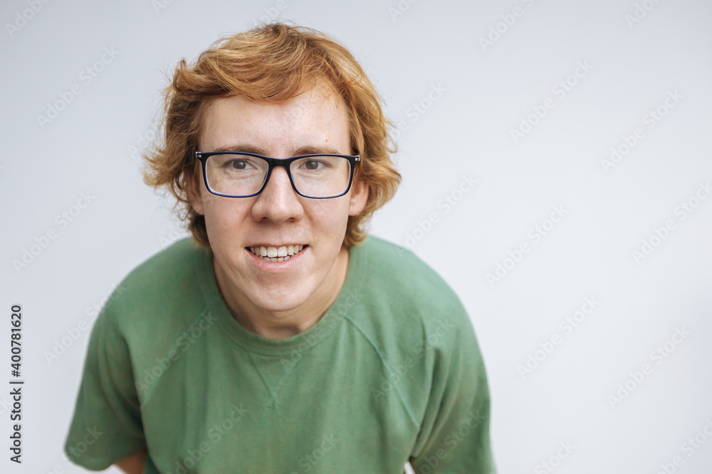 portrait of a red-haired man with glasses on a light background portrait of a red-haired man with glasses on a light background