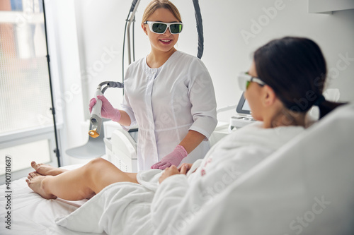 Doctor holding a laser hair removal device