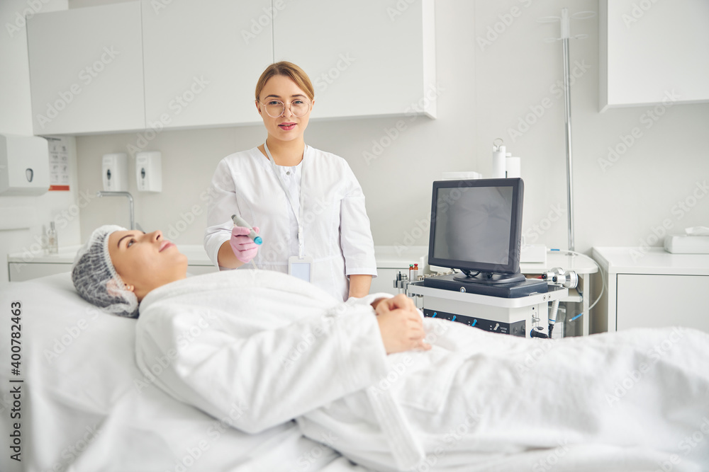 Woman patient lying on the couch in a beauty salon Woman patient lying on the couch in a beauty salon
