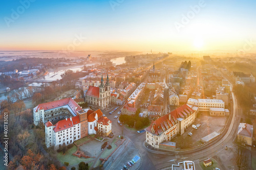 Brzeg, Poland. Aerial cityscape on sunrise with Piast castle and Church of the Holy Cross photo