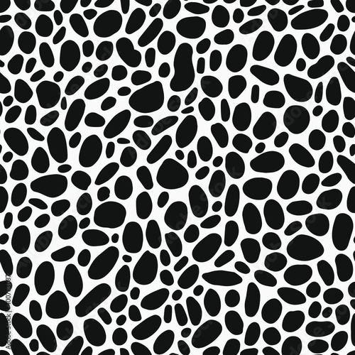 Randomly placed round elements to seamless pattern. Black and white dots like leo all over graphic.