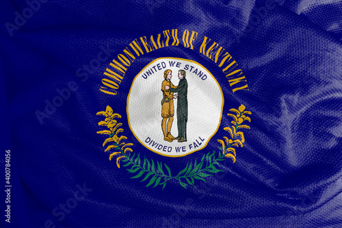 The Kentucky flag is a flag with the seal of Kentucky on a navy blue field, surrounded by the words Commonwealth or Kentucky at the top and golden twigs at the bottom. 