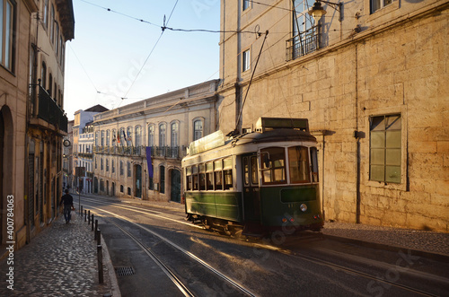 Sunset time at Alfama with a tram passing by.