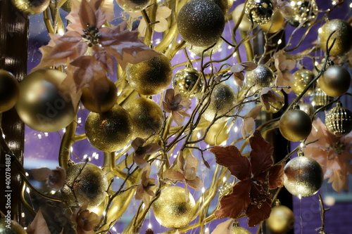 New Year's festive decorations of manors in yellow shades on a purple background. Christmas decorations. Festive room design. Artistic work. Fun mood. The atmosphere of a fairy tale and mystery