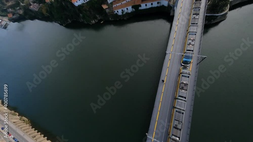 Train crosses grey bridge FPV drone dive over Dom Luis bridge Porto Portugal photo