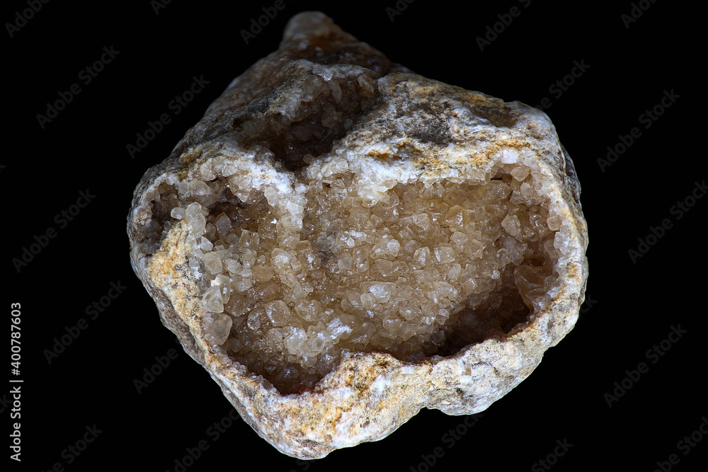 Crystalline calcite geode (CaCO3) in limestone on black background
Crystalline calcite geode (CaCO3) in limestone on black background