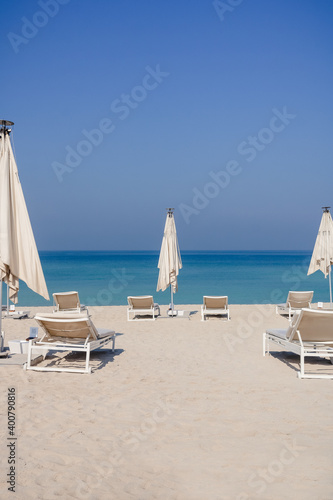 Relaxing empty beach with sun bed  sea landscape. Summer vacation travel holiday concept.