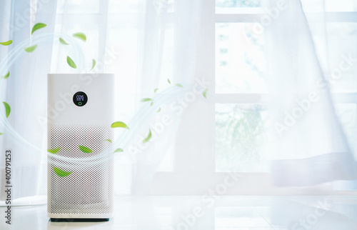 air purifier a living room,  air cleaner removing fine dust in house. protect PM 2.5 dust and air pollution concept photo